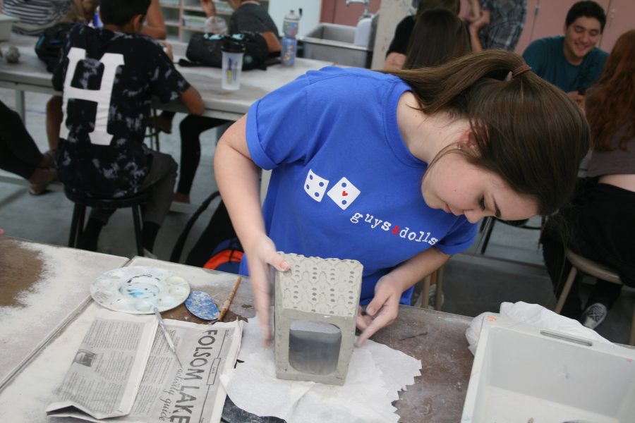HARDWORKING ART: In Mr. Ron Owens ceramics class, junior Bailey Bradford smooths out the edges of her box. Bradford wanted to make it look nice since she will have it for a long time. “I take as much time as I need so I can get my best quality work,” Bradford said. Photo by Nishita Fernandes