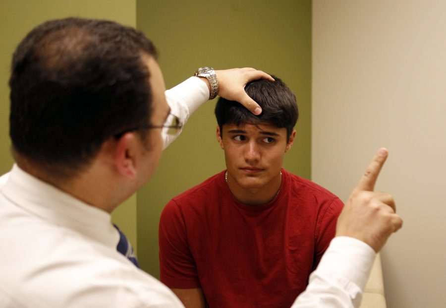 Troy Piccinini, a junior football player at Conant high school is evaluated by Dr. Hossam Abdelsalam, Pediatric Neurologist at the Neurosciences Institute at Alexian Brothers Health System, in Elk Grove Village, Illinois, August 17, 2011. (Nuccio DiNuzzo/Chicago Tribune/MCT)