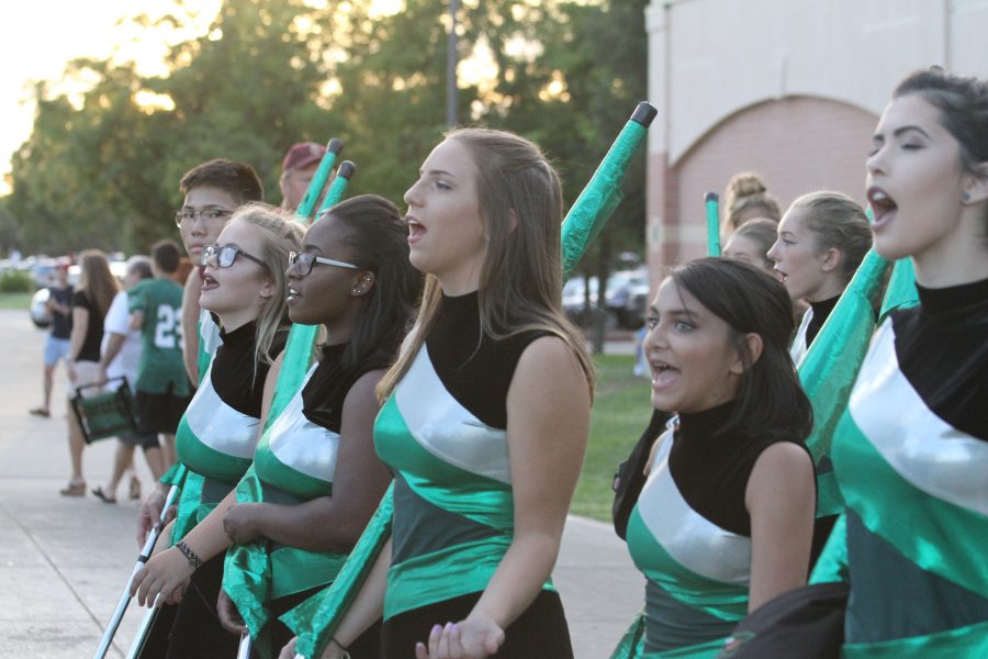 Twirling for her school: Color guard member Katharine Strong, freshman, prepares for homecoming