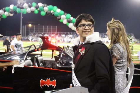 Senior King Rami Sadek and Queen Taylor Harris celebrate their victory with a ride in the Bat-Mobile.