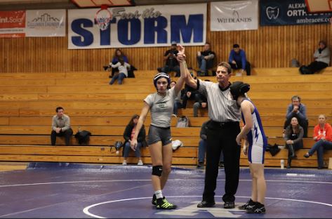 Victoria Wells, a freshman at GBHS raises her hand after winning a match against league rival Rocklin.