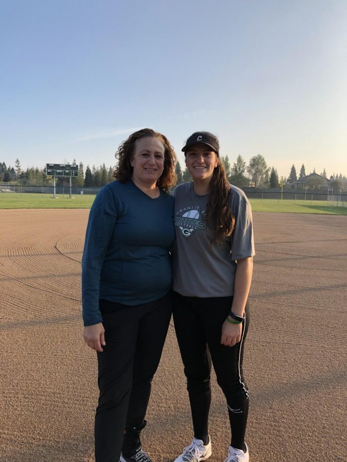 Lindsey Poulos poses with her mother, Michele Granger on the softball field after softball practice.
