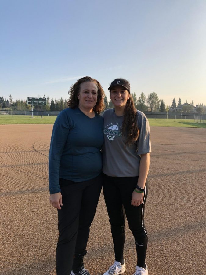 Lindsey+Poulos+poses+with+her+mother%2C+Michele+Granger+on+the+softball+field+after+softball+practice.