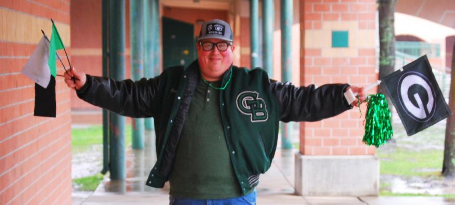 Noah Frank poses with his favorite tribe gear that he wears to every varsity football game.  Frank is often seen with this gear at the front of the stands, cheering on the team. 