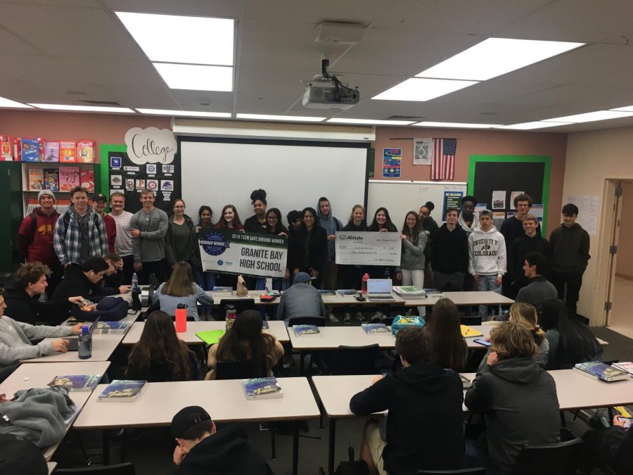 The Sports and Entertainment Marketing class receives a $1,500 check and a banner after getting first place in the Teen Safe Driving Campaign put on by Allstate.
