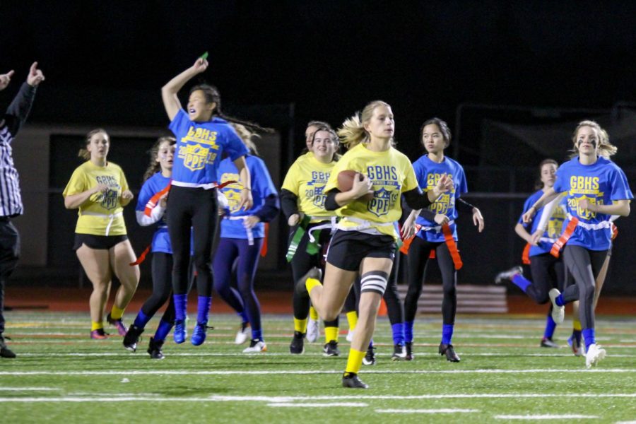 Maddy Fitch's flag is pulled as she runs by the junior defense. 