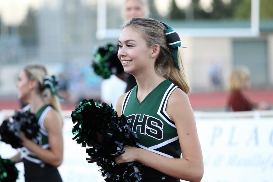 Claire Chanter cheers on the crowd with pompoms before the game.