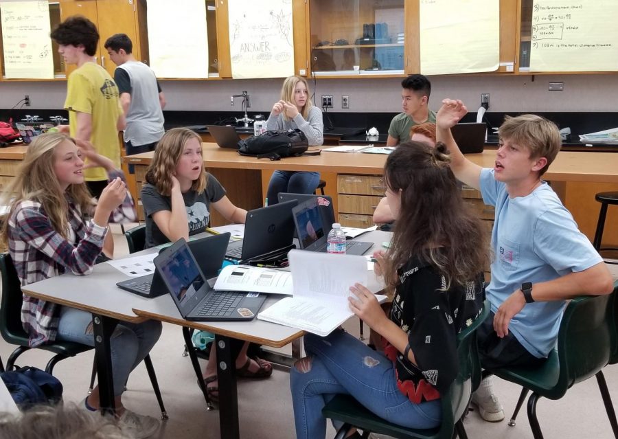 Students+in+NGSS+physics+use+their+chromebooks+for+an+in+class+activity.