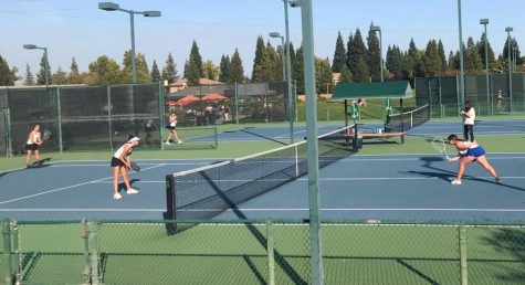 Kaylee Price and Raylie Dawson play Rocklin at their JV match on Monday.