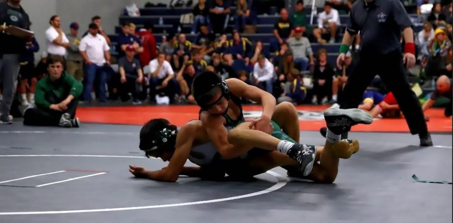 Sophomore Talon Niimi wrestles against an opponent during his 2019 winter season. 