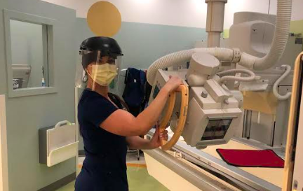 Britni Rowe, a radiologist at Kaiser Hospital Roseville, poses  must wear extensive amounts of  PPE, or personal protective equipment, during the coronavirus pandemic.