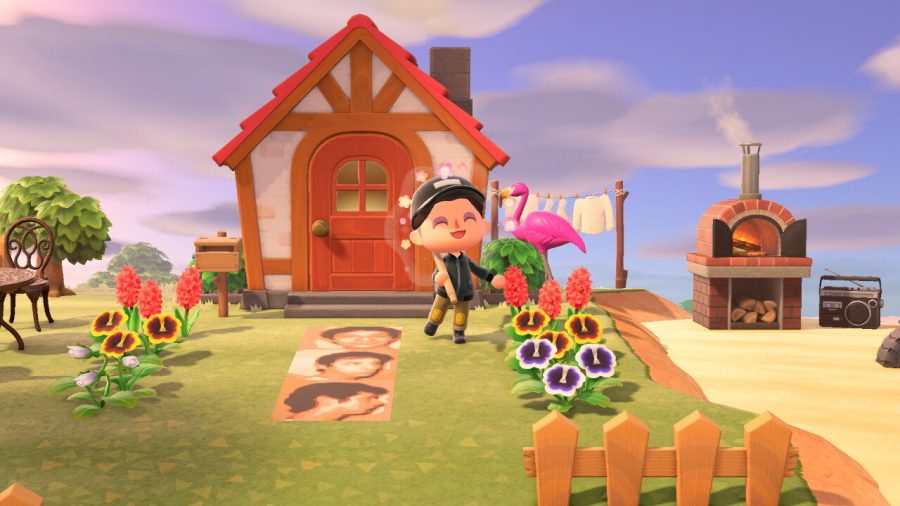 The player character in Animal Crossing: New Horizons poses to show off their home.
