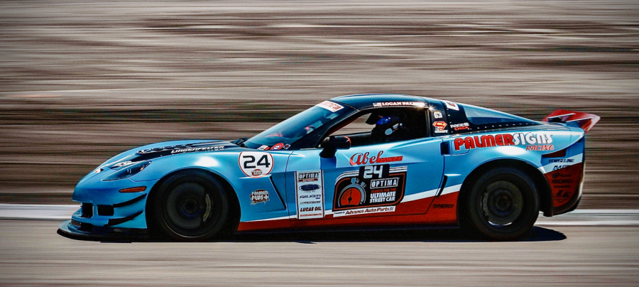 Professional race car driver Logan Palmer speeds around the race track at All American Speedway.