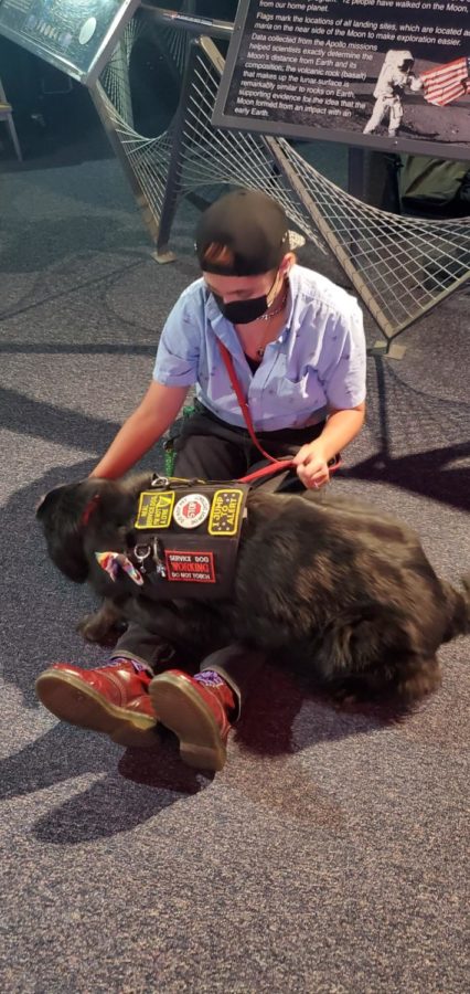 Service dog, Molly, provides deep pressure therapy for Jayde Barnett.