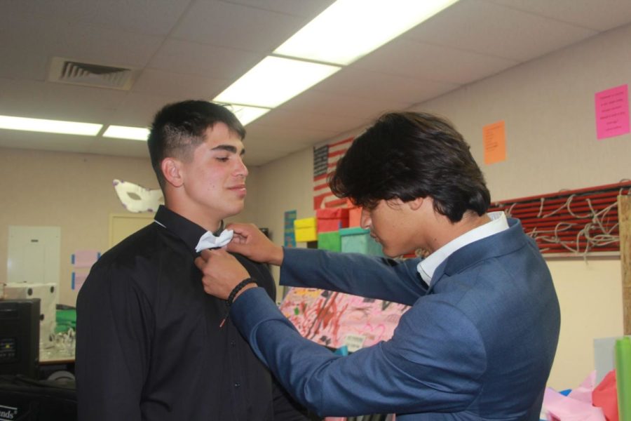 Before+walking+out+in+front+of+all+students+and+teachers+at+the+royalty+rally%2C+sophomore+royalty+candidate%2C+Peter+Caldera%2C+helps+fix+Frank+Cusanos+bow+tie.