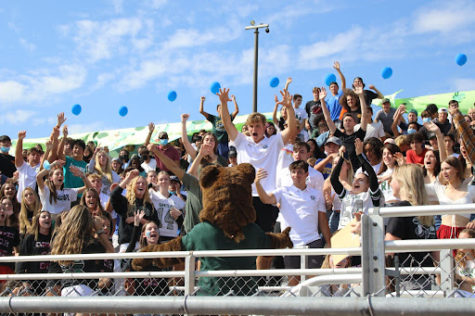 The crowd goes wild when the school mascot, Big G, makes his way through the bleachers to greet students during the homecoming spirit rally.