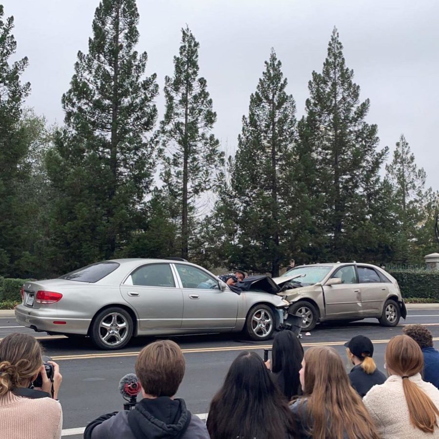 Juniors and seniors gather to observe the opening presentation of the car crash scene of Every 15 Minutes.