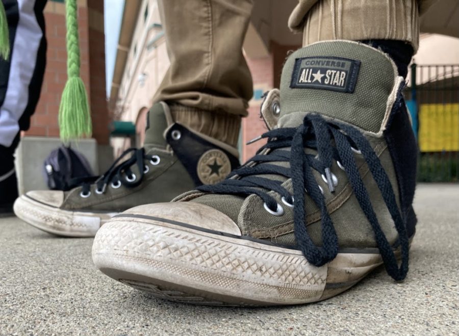 Sophomore Joaquin Ralph sporting his worn army green Converse Axles; These shoes feature a classic Converse appearance combined with a more laid-back style, promoting comfort and aesthetic. “It gives me nostalgia and mainly comfort,” said Ralph, “Ive been wearing...the same style and brand for the past five years or so.”