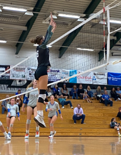 Abigayle Gotwals jumps to block a swing from the Rocklin High School Varsity Volleyball team on Sep. 19, 2022. 
