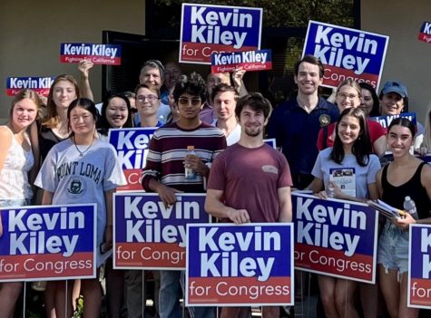 Junior Ilan Sankar and other  Team Kevin Kiley interns hold campaign signs  with their candidate before a precinct walk. 