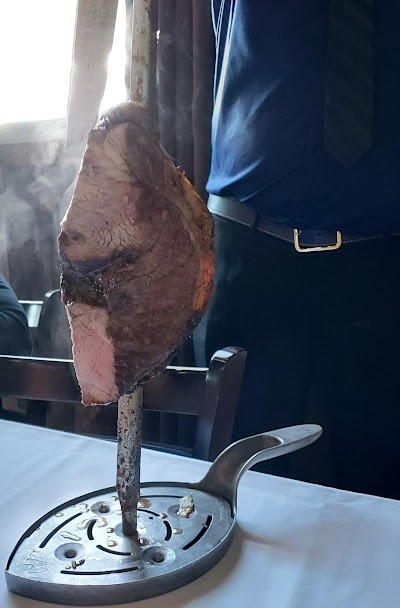 One of the waiters came by the table, and cut a slice of fresh steak for everyone at the table.