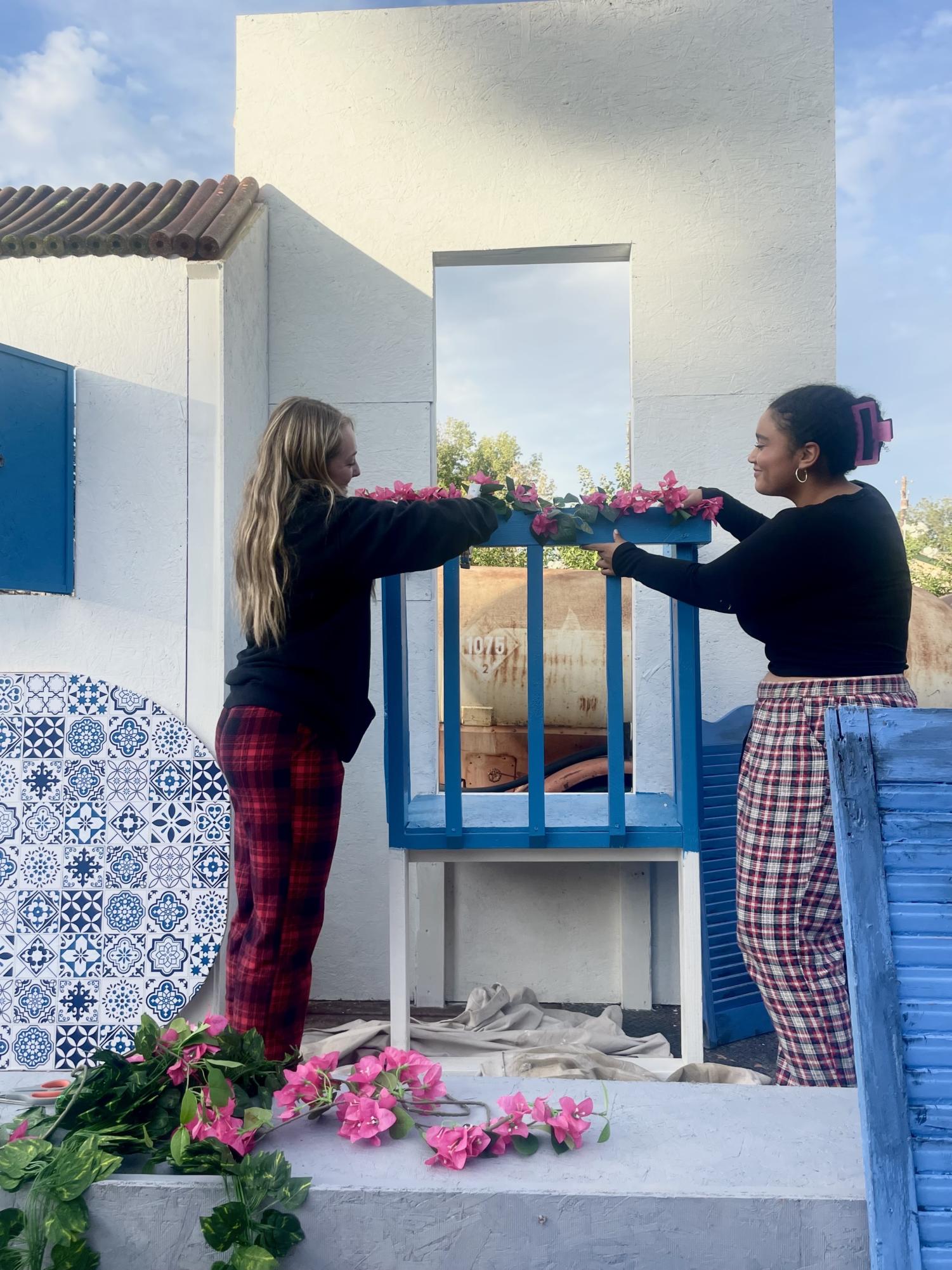 Granite Bay seniors Peyton Ledger and Layla Williams carefully staple flowers and vines to the balcony of the Mamma Mia float. 