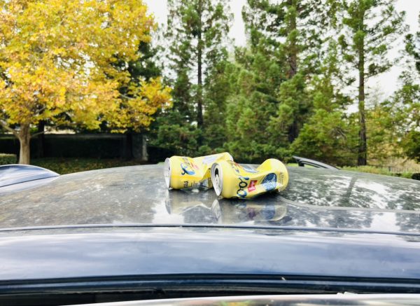 Beer cans are placed on top of a car to represent the cause of these deaths. 