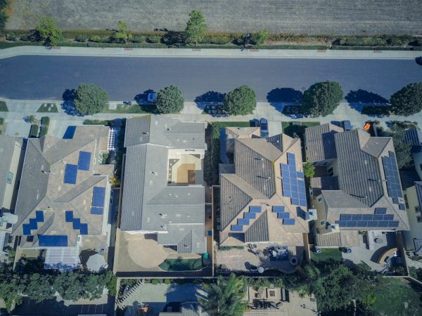 Aerial View of Houses with Solar Panels Along the Road

Creative Commons