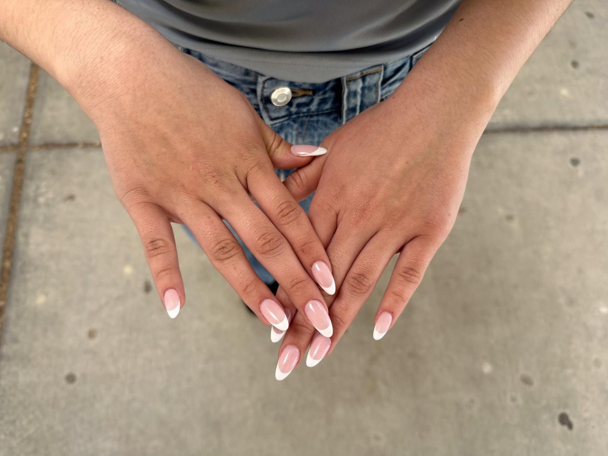 Eva Greinic gets Gel X nails consistently (every 3 weeks) and goes to Beauty House Nails in Folsom. “I like how they look and they just make me feel more put together and clean,” Greinic said. She paired her French Tips with a black velvet dress.

