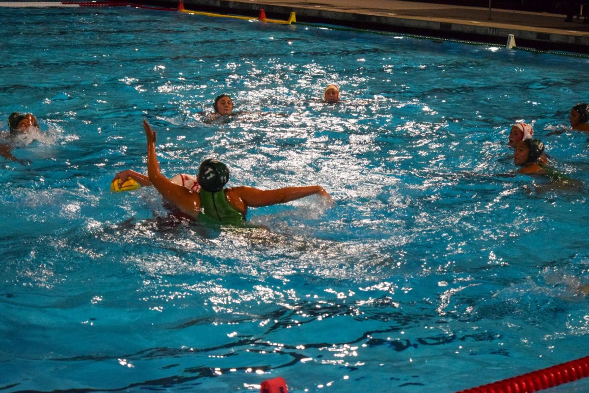 Bridget Manke, a Junior at Granite Bay High School puts a great effort into stopping the other team from shooting it in the goal.
