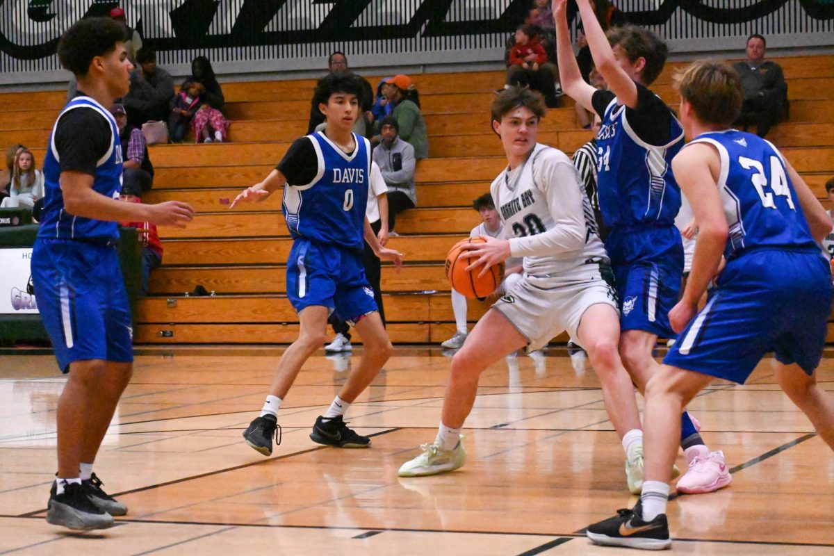 Cornered in by Davis' players, Austin Lawrence (30) tries his best to navigate out or find a teammate to make a pass to.