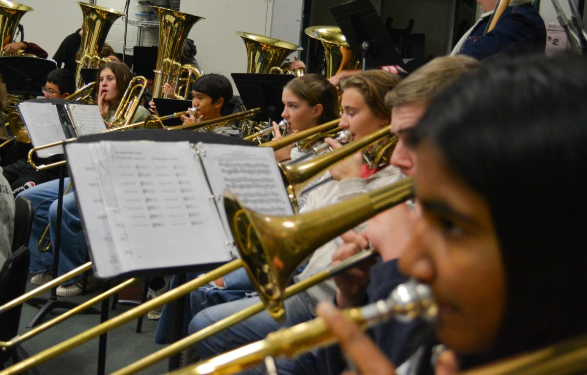 One of the band's biggest and most important instruments is the Trombone. This section consists mostly of new member Freshmen including Reva Vallurupi, Kyle Vadnais, Lily Brooks, Caleb Adriano and William Xiong. They also have a few returning members helping these new musicians such as Nolan Meier, Lilli Collamer and Concert band members Keith Vance and Niko Kartvelli. These hardworking musicians have been working extremely hard since July in their Band Camp and performing their best. In this photo, these musicians are all practicing their important parts and are preparing for their teacher Lewis to call the band and rehearse together as a whole. "It's fun, because we are all good friends...and we all like to help and support each other," Lily Brooks said, "I usually distance myself so I don't get stressed out, I'll warm up and breathe so I'm chill."