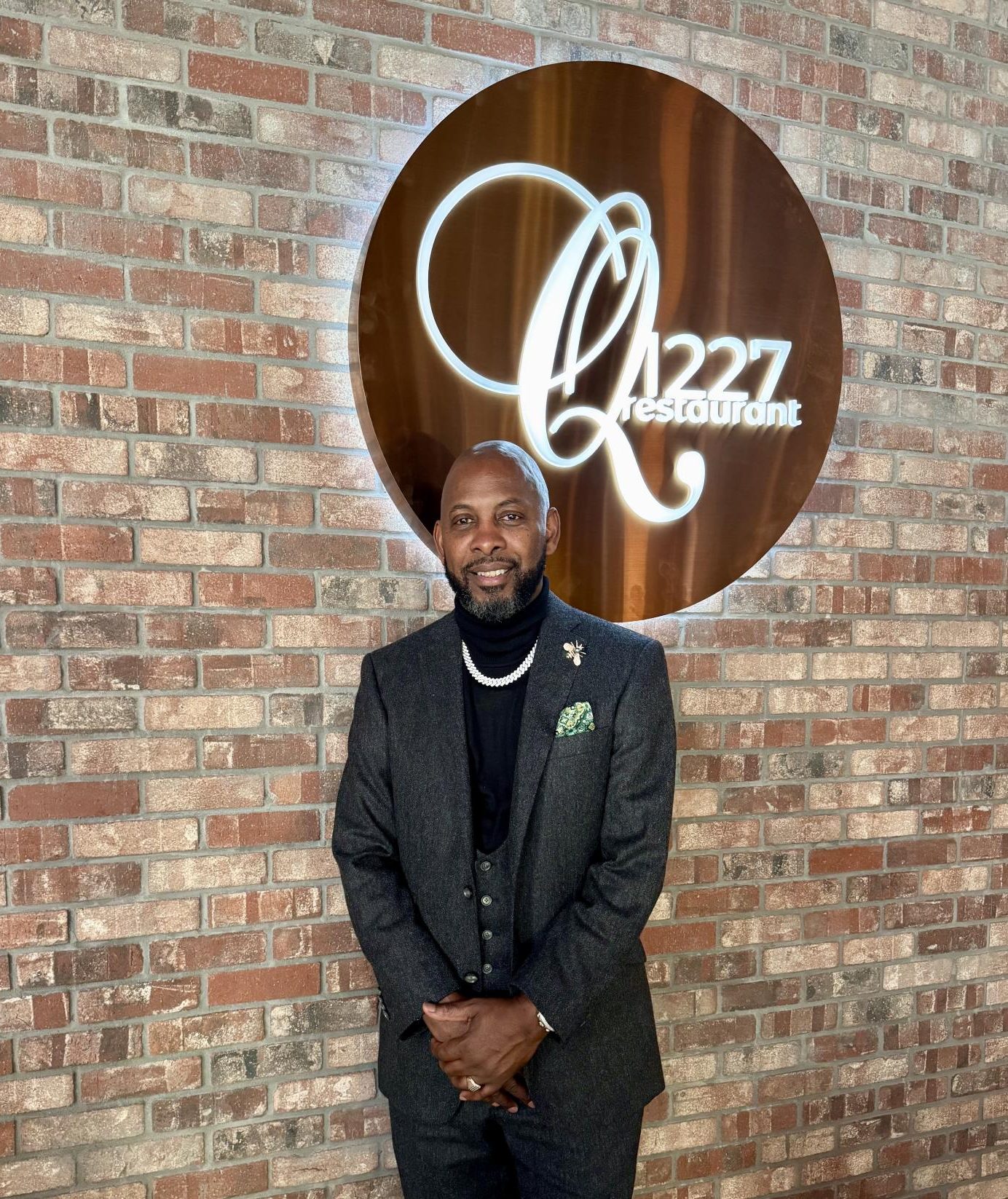 Quentin Bennett, better known as Chef Q, standing in front of his restaurant. 