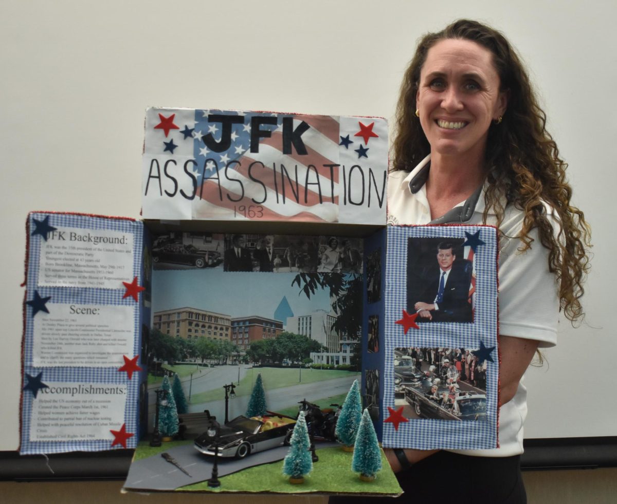 Emilie Taylor with one of her students projects on the John F. Kennedy assassination. 