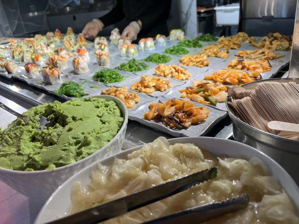 Sushi Buffet including side dishes like a Korean seaweed salad, accompanied with wasabi and radish