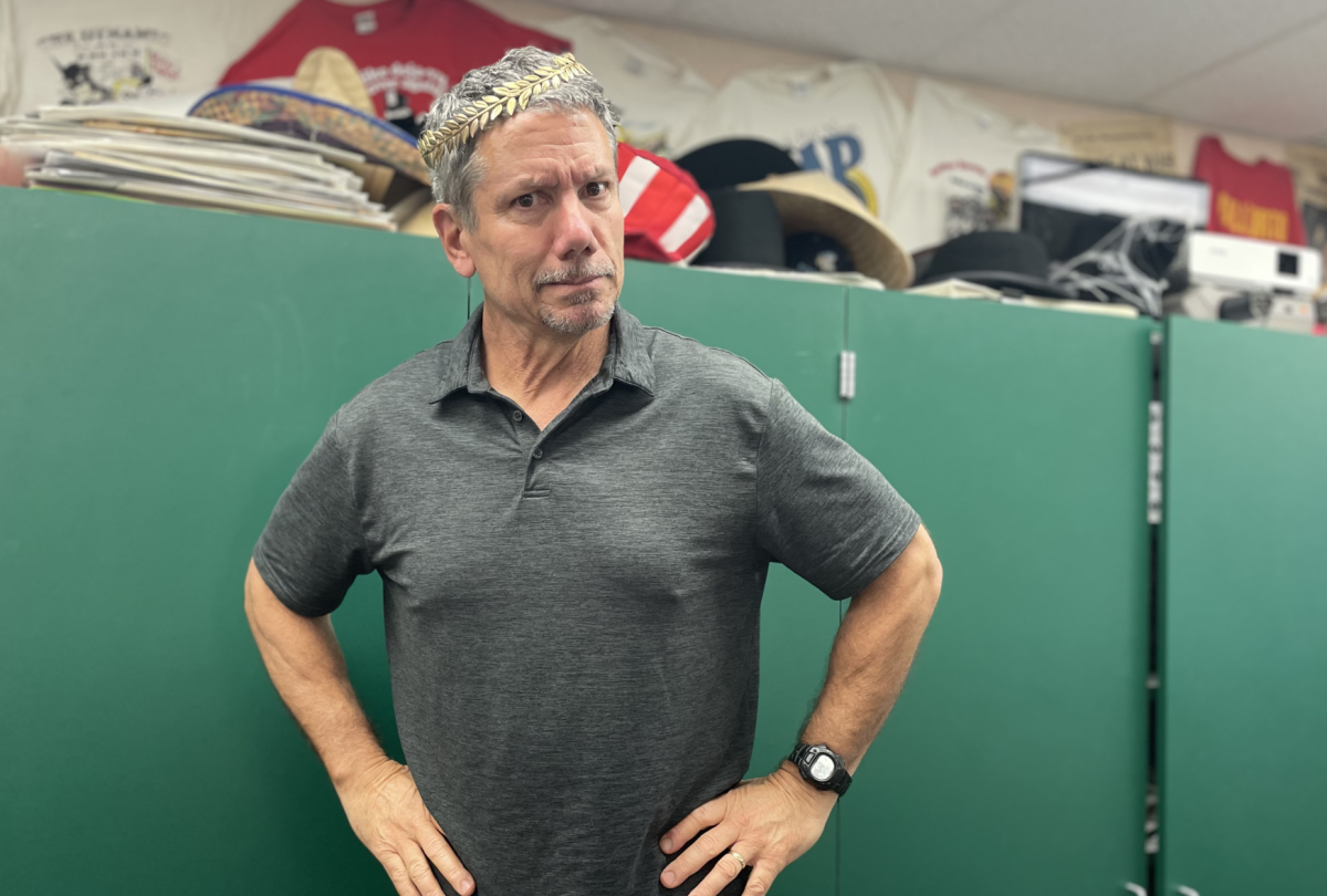 Social Studies teacher, Brandon Dell'Orto, asks all of his students to wear a paper crown with their names on it in the first few weeks of school. Here, he is wearing his crown.