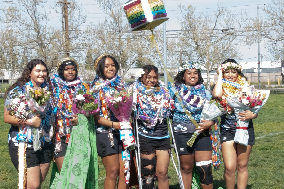 Seniors apart of the high school girl's Amazon's take a picture together before playing their last ever home game.